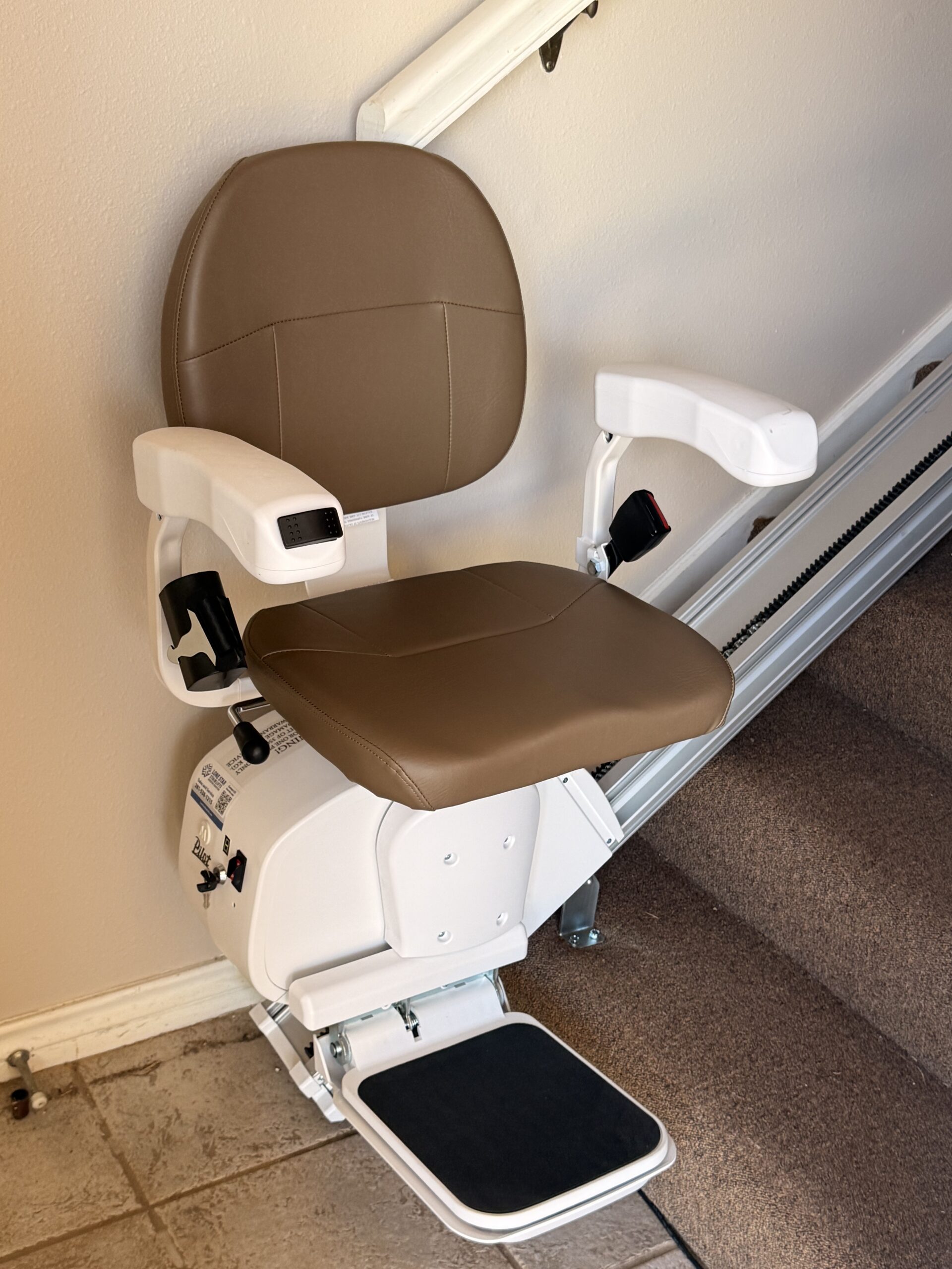 The Pilot Aviator E603 Straight Stairlift with Dark Brown Upholstery in 45° swivel position